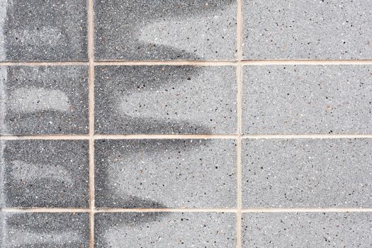 Damp patches on a grey stone wall