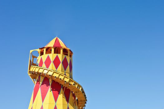 A colorful helter skelter tower on a summer day