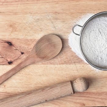 Baking items and flour on a wooden surface