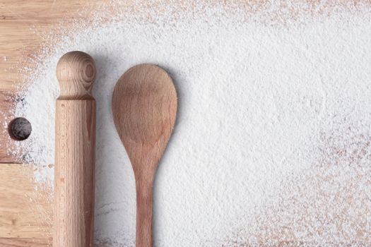 Baking items and flour on a wooden surface