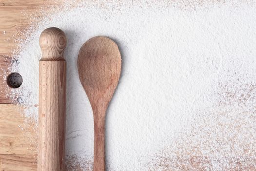 Baking items and flour on a wooden surface