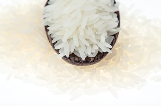 Rice grain in wooden spoon on white background  :  Selective Focus