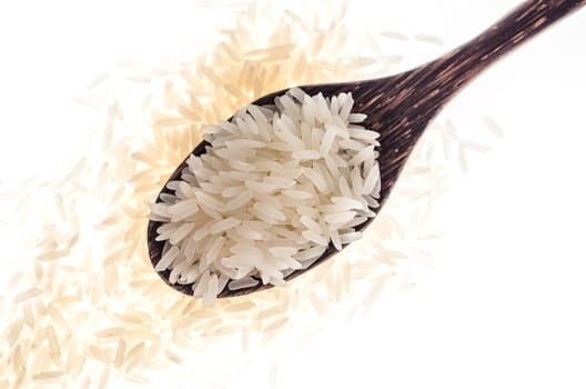 Rice grain in wooden spoon on white background  :  Selective Focus