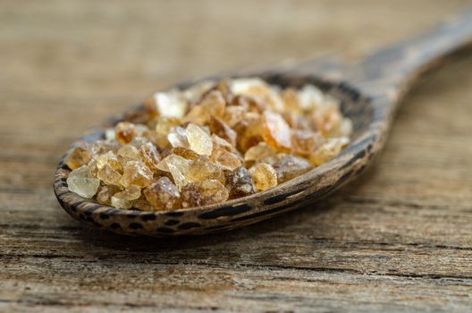 close up of crystalline sugar and wooden spoon on wooden table : Selective Focus