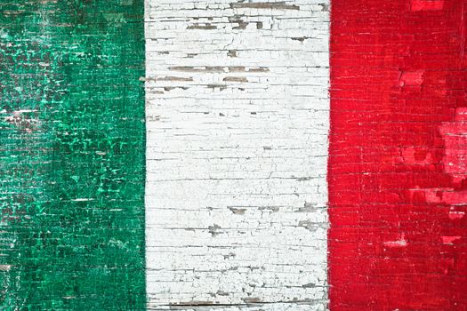 Colors of the Italian flag painted on a weathered wood background