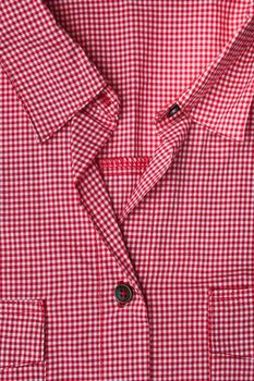 Front of a red gingham blouse showing pockets,collar and buttons