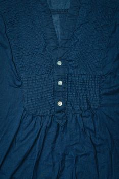 Close up of the buttons of a dark blue ladies' top