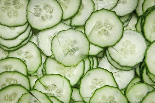Freshly sliced cucmber pieces as a background
