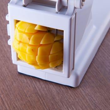 A Potatoes cutter over a wooden background