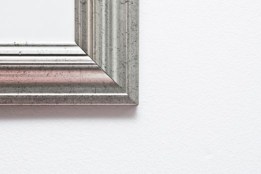 Corner of a picture frame on a white wall