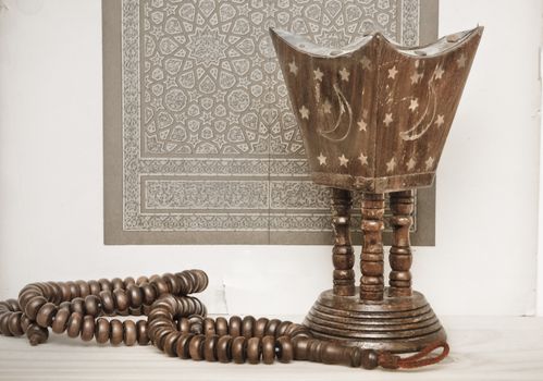 Islamic art and prayer beads with an incense burner, suggesting a meditative theme