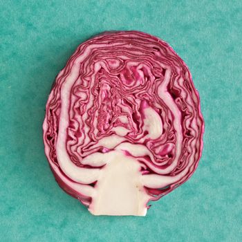 Slice of red cabbage  on a green background