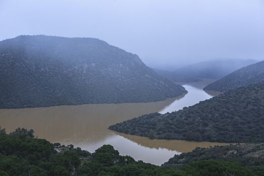 Reservoir of the Jaen in winter at full capacity after heavy rains, taken just before starting to snow, Parque Natural de Sierra Morena, Andujar, Andalusia, Spain