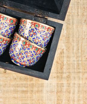 Traditional middle eastern tea cups in a wooden box