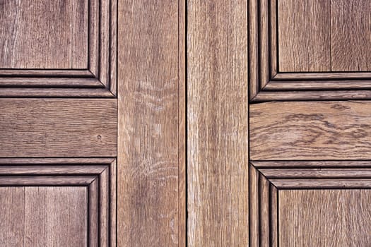 Close up of the panels of an old wooden door