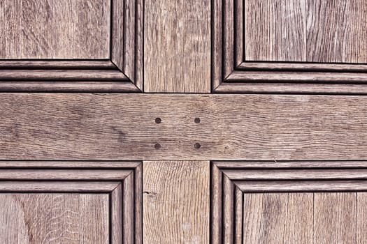 Close up of the panels of an old wooden door