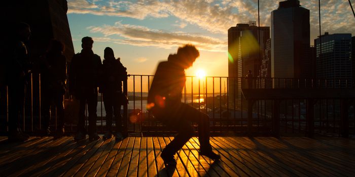 Man dancing on terrace at sunset, Midtown, Manhattan, New York City, New York State, USA