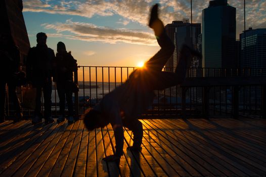 Man dancing on terrace at sunset, Midtown, Manhattan, New York City, New York State, USA