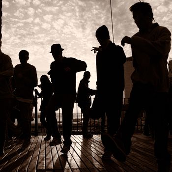 Men dancing on terrace at sunset, Midtown, Manhattan, New York City, New York State, USA