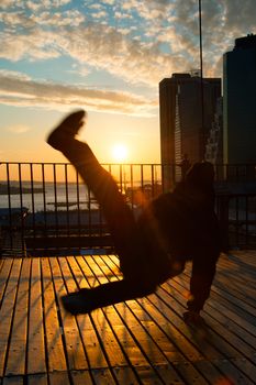 Man dancing on terrace at sunset, Midtown, Manhattan, New York City, New York State, USA