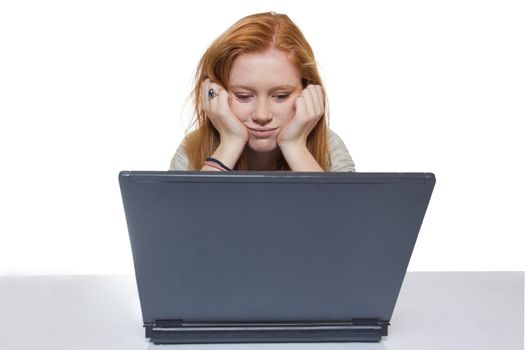 Female student sitting bored and frustrated in front of the computer