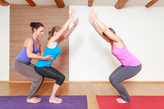 An image of some people doing yoga exercises