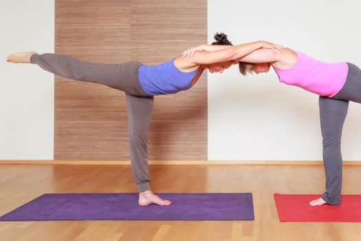 An image of some people doing yoga exercises