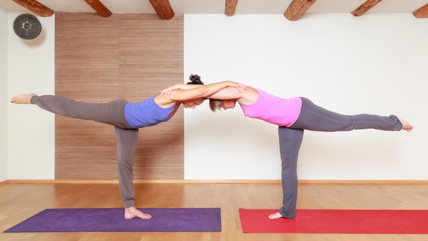 An image of some people doing yoga exercises