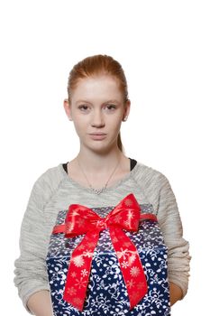 Young well dressed red haired Girl presents present with a big smile