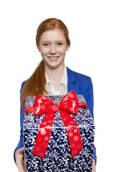 Young red haired businesswoman presents present with a big smile