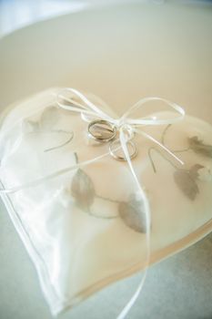 White Heart Shaped Pad with Wedding Rings