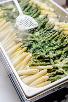 Buffet with prepared asparagus on a silver tray