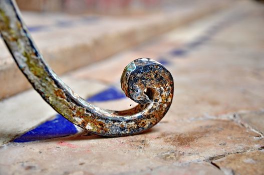 Leg of an iron chair on Moroccon type tiles