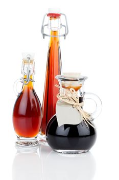 maple syrup in glass bottle or herbal syrup, ardent drink, mixture, with heart label. on white background.