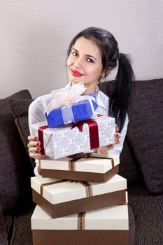 beautiful woman holds many boxes of gifts