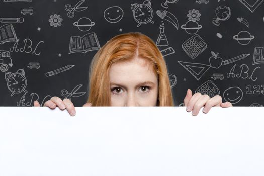 Cute teen girl holding a white sign