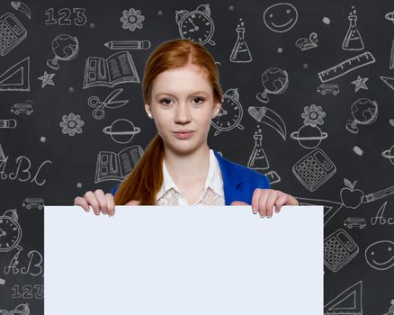 Teen girl holding a sign with copyspace for adverts