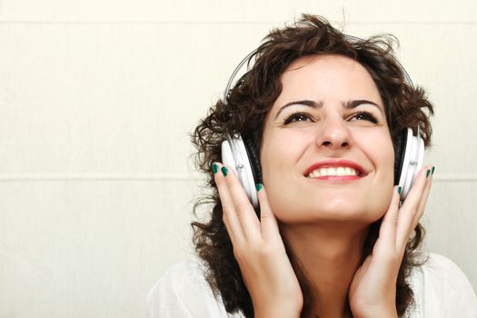 A young woman listening music with Headphones.