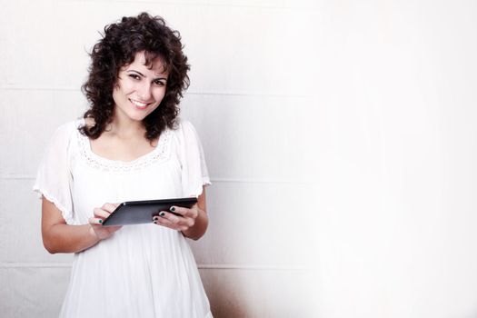 A young woman holding a Tablet PC.