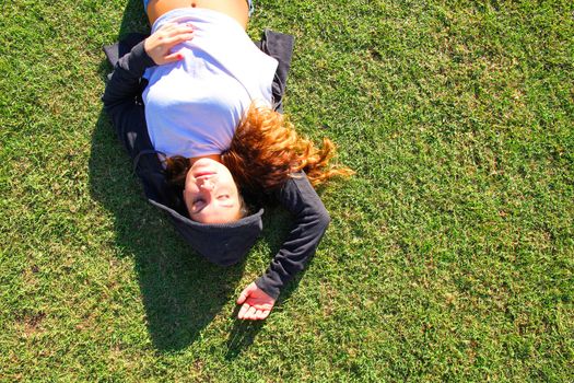 A young woman enjoying the sunlight in the Park.			
