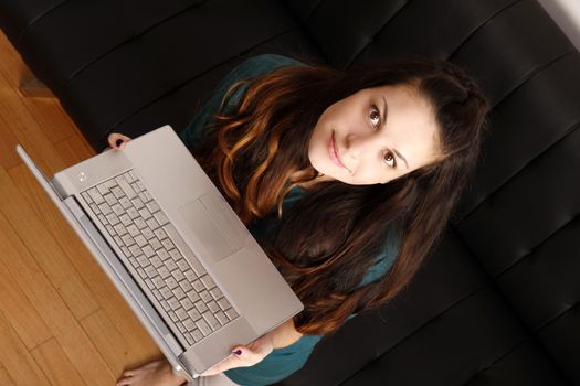 A young hispanic girl with a laptop. 