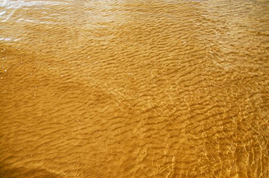 water and sand patterns of the sea yellow bottom