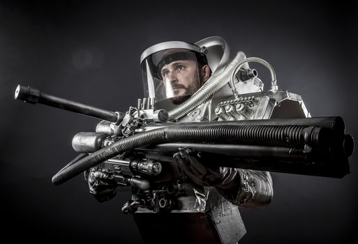 Spacesuit, Astronaut on a black background with huge weapon.