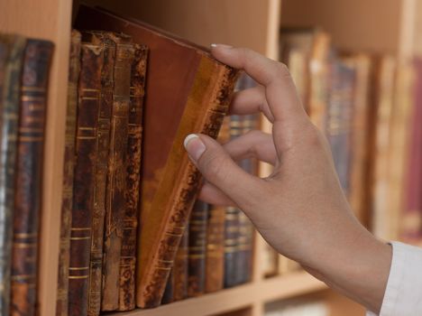 woman hand holding old book library close up