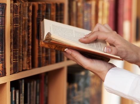 woman hands reading ancient book