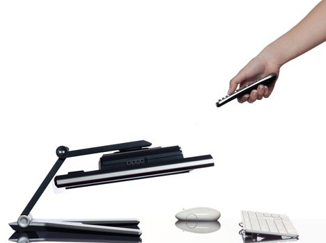 human hand holding remote control and a computer display monitor on isolated white background expressing failure concept