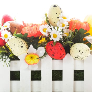 Easter decorations: flowers and eggs isolated on white