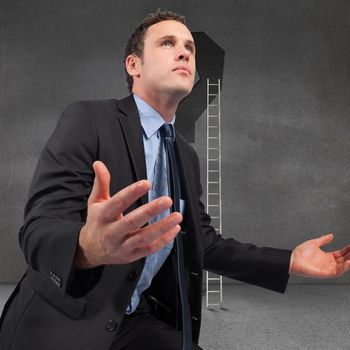 Businessman posing with arms out against punctuation in grey room