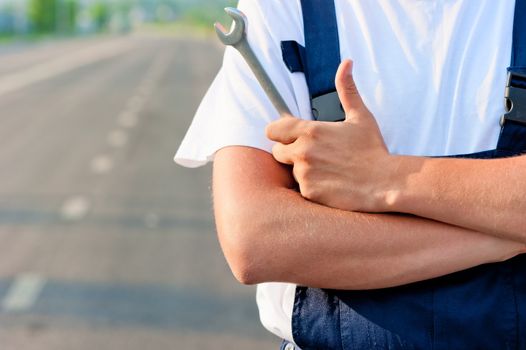 wrench in hand mechanic in overalls