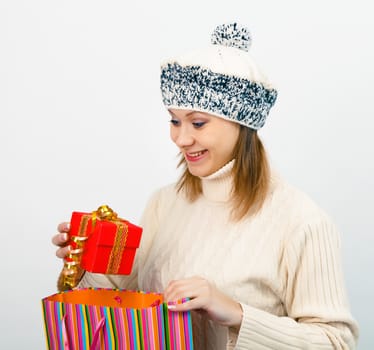 young beautiful woman in winter hat with gifts